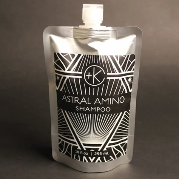 a silver packet of refillable plastic free conditioner holds a clean non toxic eco friendly amino acid shampoo.