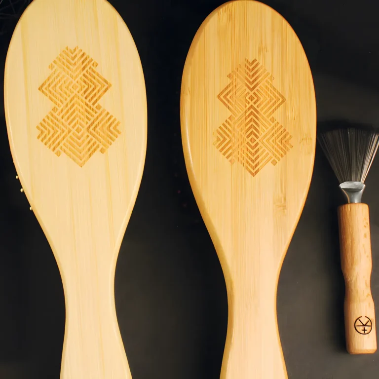 Cult+King bamboo and boar bristle brushes — eco-friendly wooden brushes with engraved geometric designs, shown alongside a small bamboo cleaning tool.