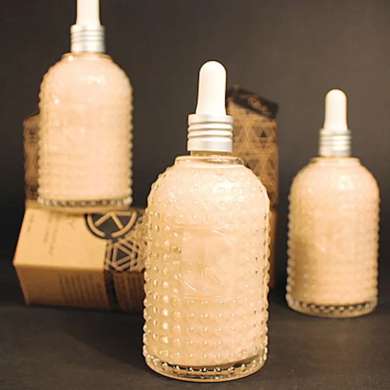 Cult+King Jelly full-size bottles — peach-toned texture infusion for hair in tall glass jars with droppers, shown with geometric packaging.
