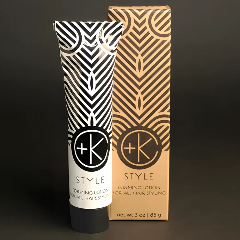 a whie aluminum tube stands next to a cardboard box it is packaged in. both have simple black imaging with repeating lines and the c+k logo.