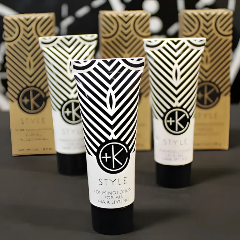 a few mini tubes in white aluminum and black writing with the c+k logo has black lids and the cardboard packaging is in the background.