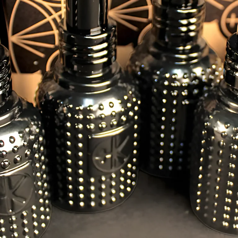a close up of a few mini bottles of tonik. they are black bottles with little dots the bottles are glass and have black lids and are perched on their obelsk cardboard packaging.
