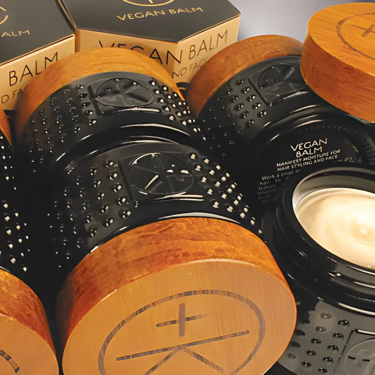 Cult+King Vegan Balm in black glass jars with wooden lids, shown in stacked packaging with open container.
