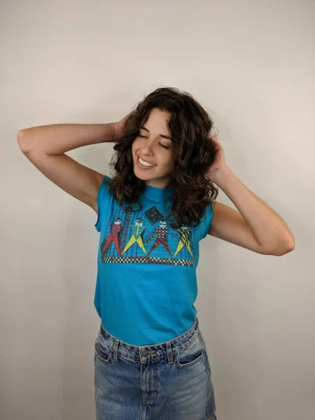 A brunette woman puts her palms on the back of her head and looks lto the side with her eyes close and elbows out sl hella stoked on her super cute haircut and she is literally feeling it