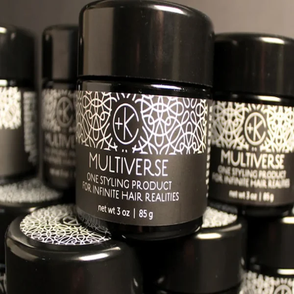 a front shot of black jars of multiverse by cult + king, the jars are black with white writing and sacred geometry
