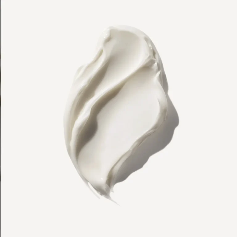 Close-up texture shot of the thick, creamy white formula of the Olaplex Rich Hydration Mask for dry hair.