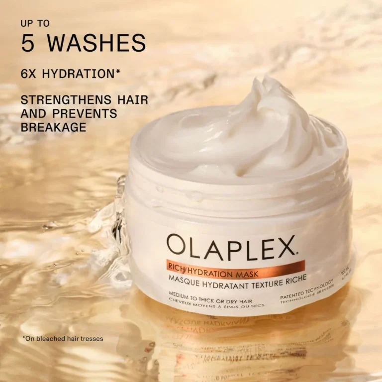 Olaplex Rich Hydration Mask jar with a scoop of the product showing its rich texture, promoting up to 5 washes of hydration, strengthening, and breakage prevention.