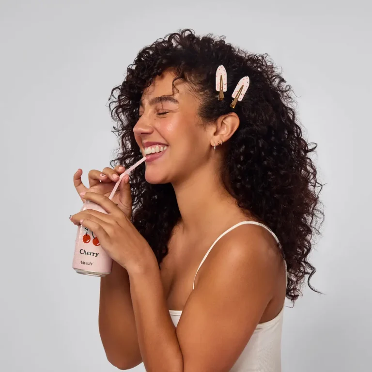 a woman with curly hair wears creaseless cherry clips by kitsch