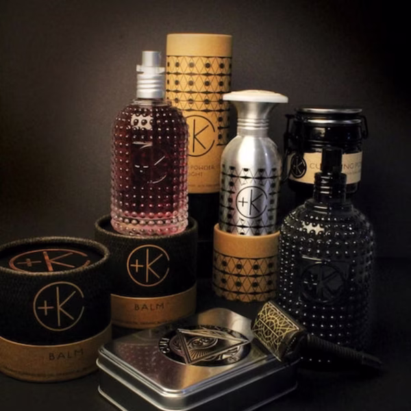 a display of cult + king products on a dark bathroom. glass, aluminum and carbdoard packaging.