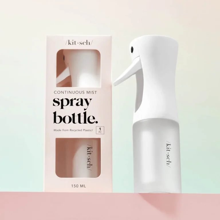 a white spray bottle stands to the side of it's twin in the packaging. on a pastel background