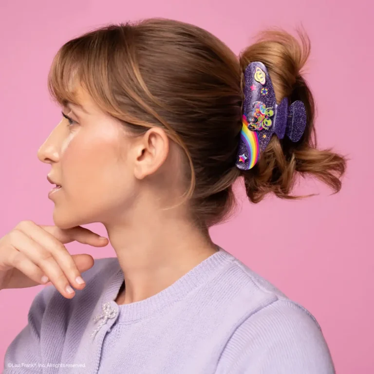 profile pic of a woman wearing a purple glitter alien lisa frank claw clip