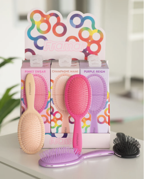 a beautiful display of framar detangling brushes in 4 colors. pinky swear, champagne mami, puprle reign and black.