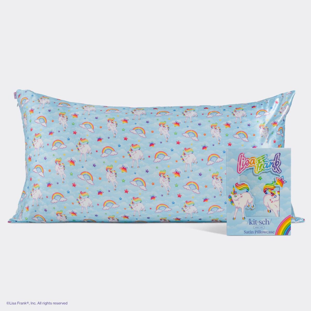 Lisa Frank x Kitsch satin pillowcase in light blue with a unicorn and rainbow pattern, shown next to its packaging