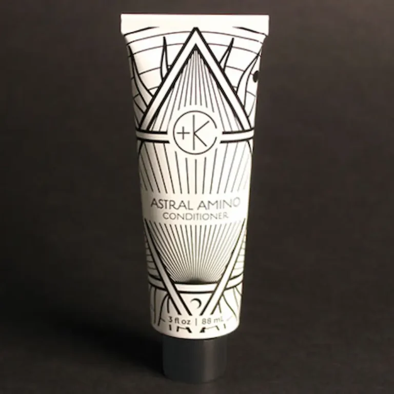 a white tube of astral amino conditioner by cult + king showing great gatsby style packaging with black and white art deco