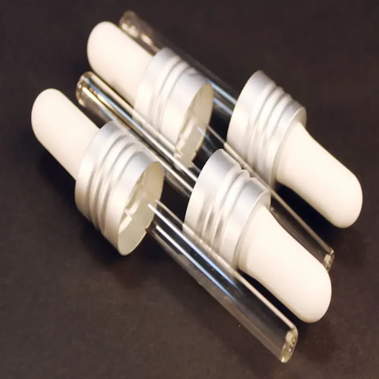 replacement mini glass droppers for cult + king jelly, white squeeze tops and clear glass body on a black background