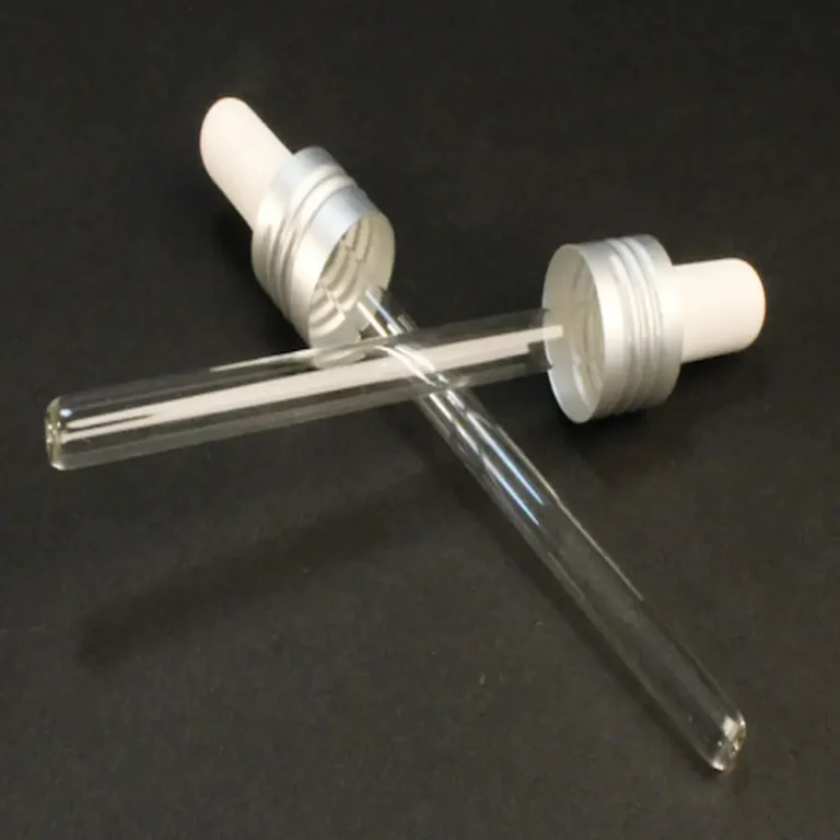 2 replacement glass droppers for full size jelly from cult + king criss crossed on a black background. the rubber squeezer on top is white and the glass is clear.