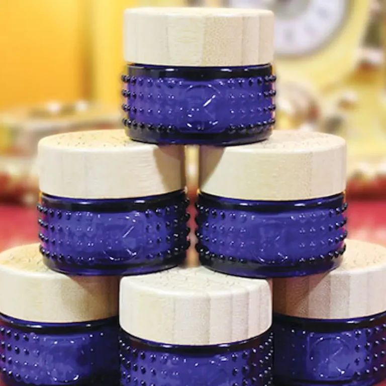 a stack of blue cobalt glass mini packaging for multiverse by cult + king