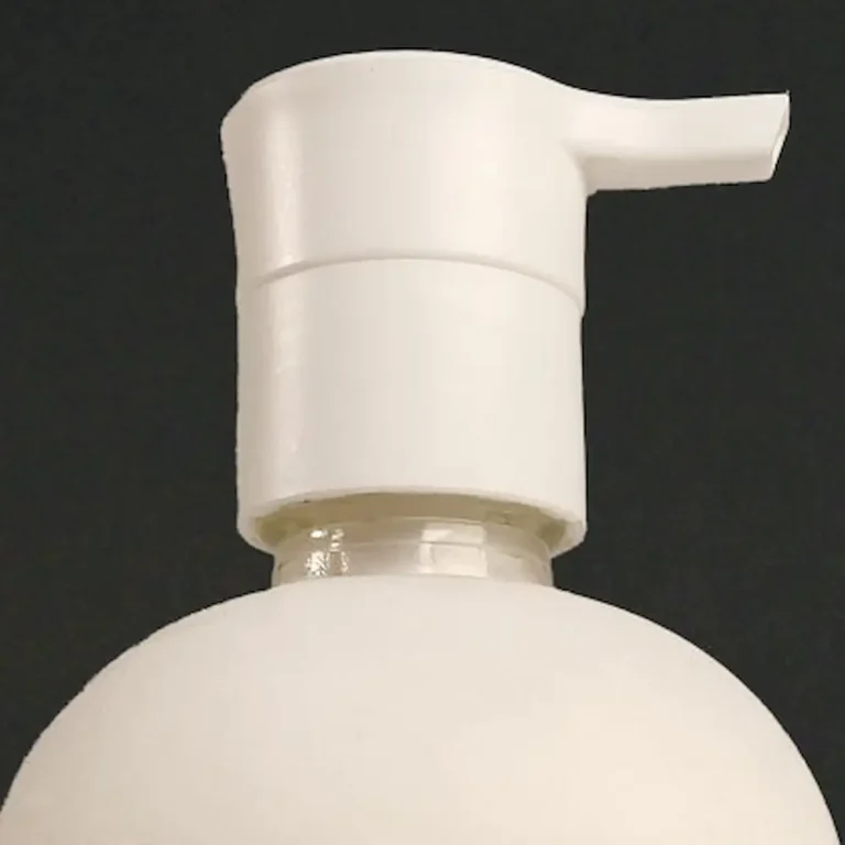 A White pump on a white bottle with a black background for creampop conditioning cleanser for hair by cult + king available in ukiah at erin reye hair.