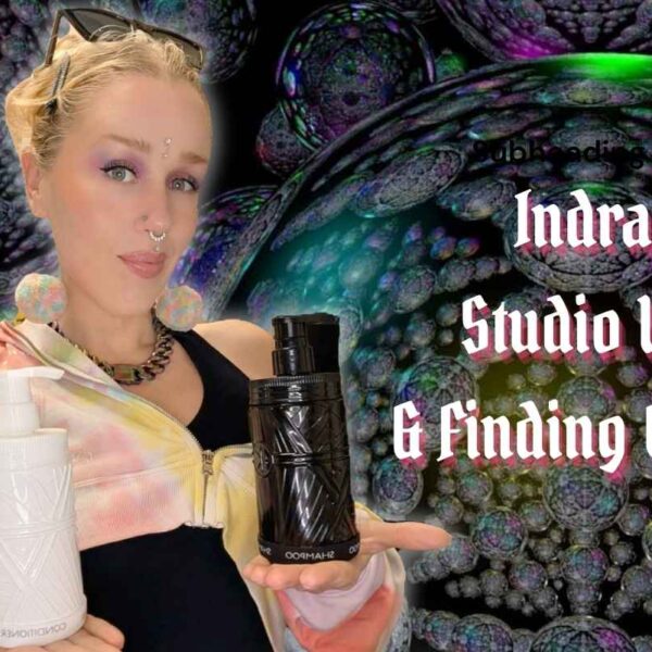 erin holds glass refillable bottles of shampoo and conditioner in front of indras net. it reads - Indras net, Studio updates, & finding connection.