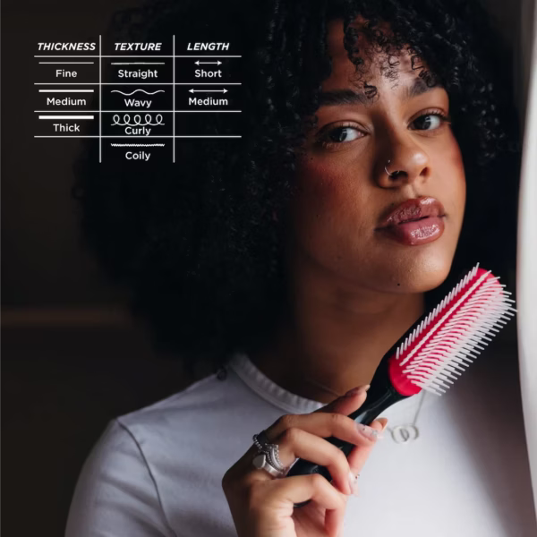 A person with curly hair holding a classic Denman D3 styling brush next to a chart showing it is ideal for fine to thick hair, straight to curly textures, and short to medium lengths.