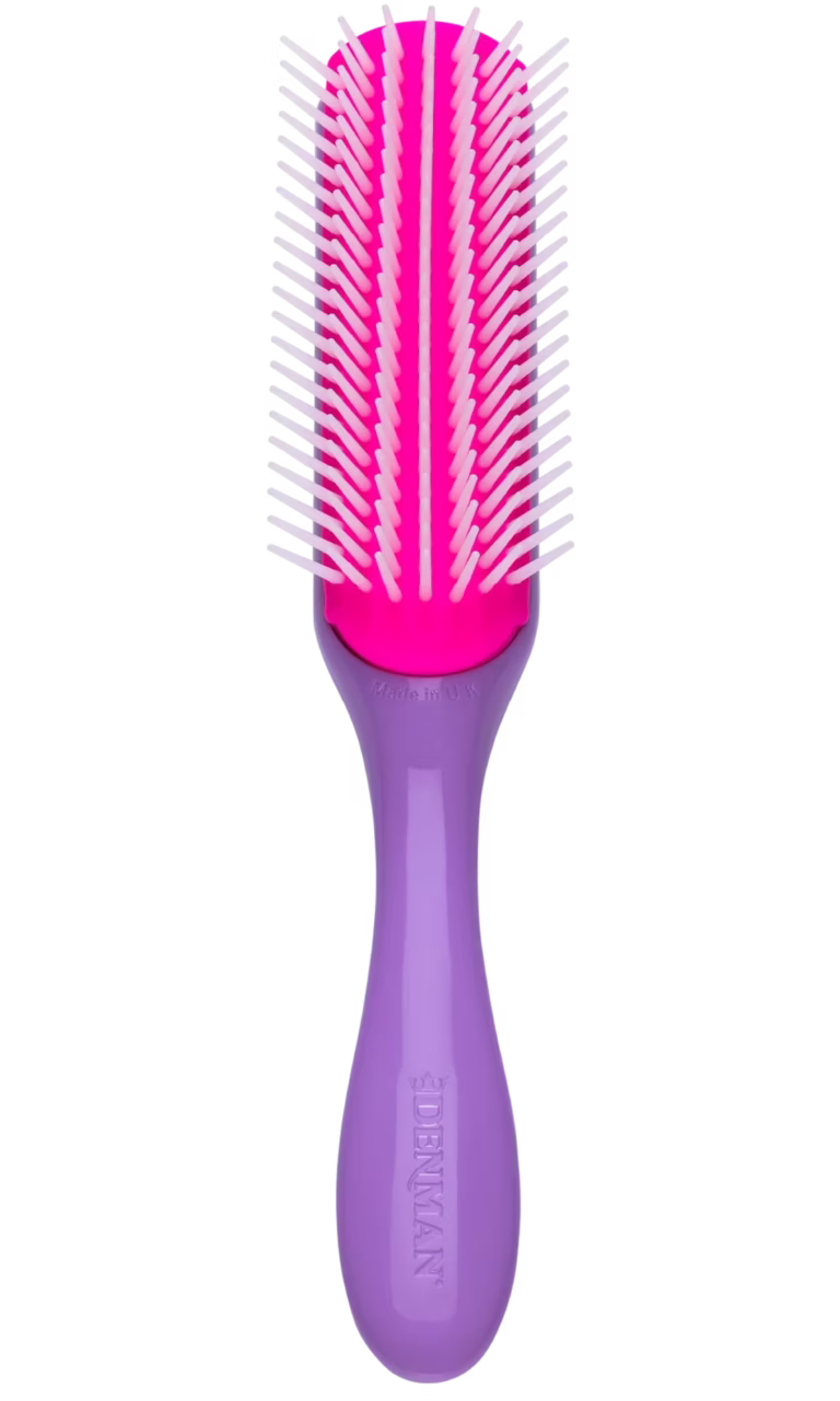 Front view of the Violet Denman D3 styling brush showing a lavender handle, a bright magenta-pink rubber cushion pad, and seven rows of white nylon pins.
