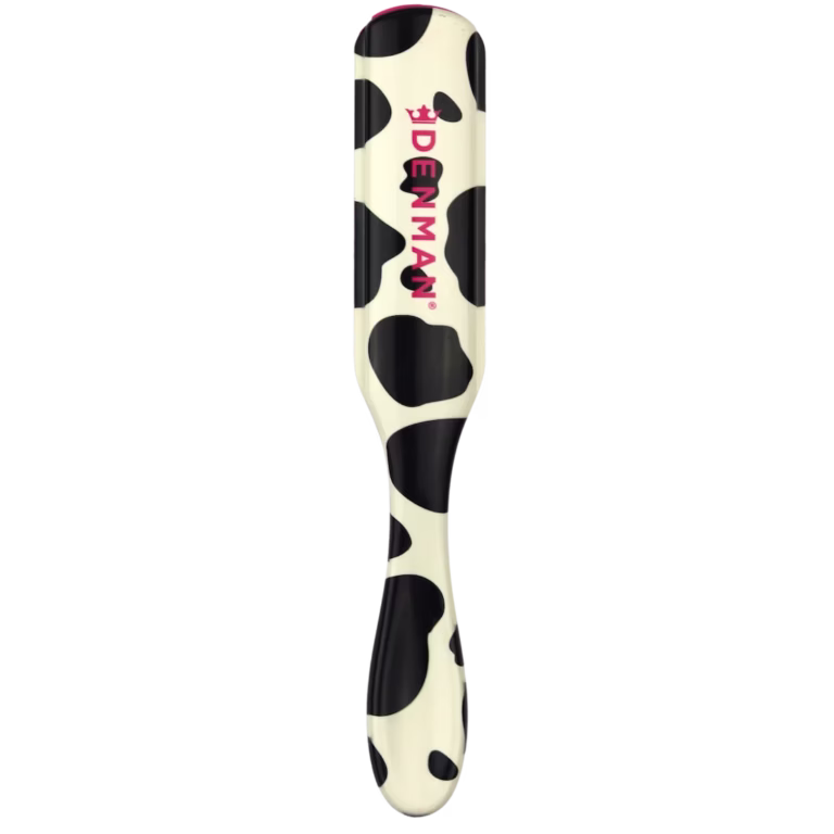 Back view of the Denman D3 Deluxe Cow print styling brush featuring a playful black and white spotted handle with a pink Denman logo.