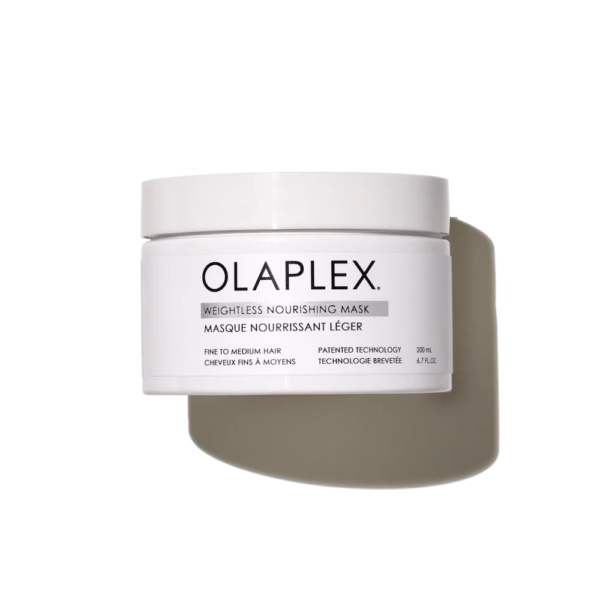 a white tub of olaplex weightless nourishing mask with a shadow behind it